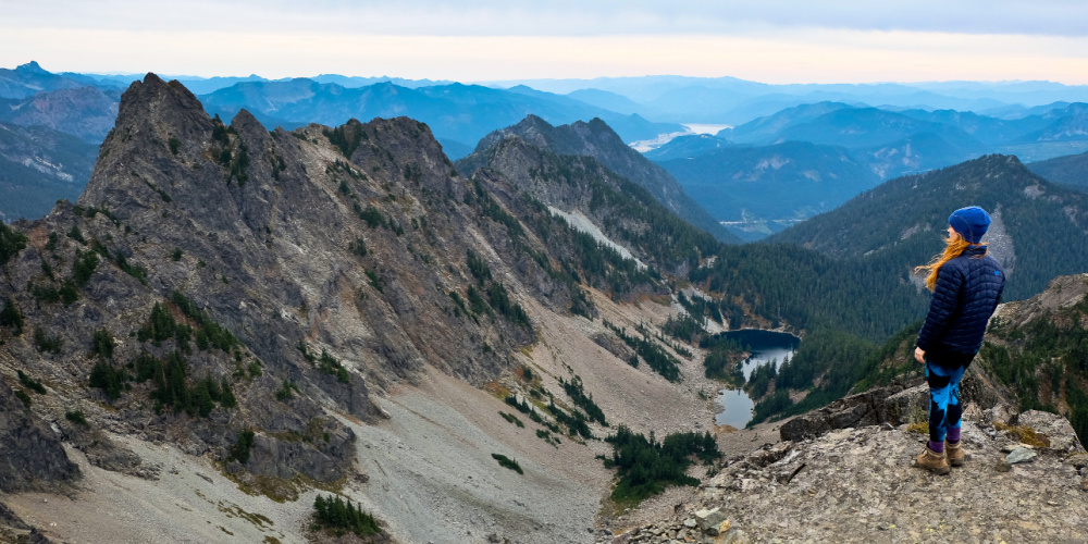 Woman looks at mountains in horizon